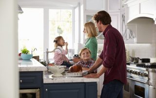 Family preparing dinner in remodeled kitchen - 4 Kitchen Design Ideas for Growing Families
